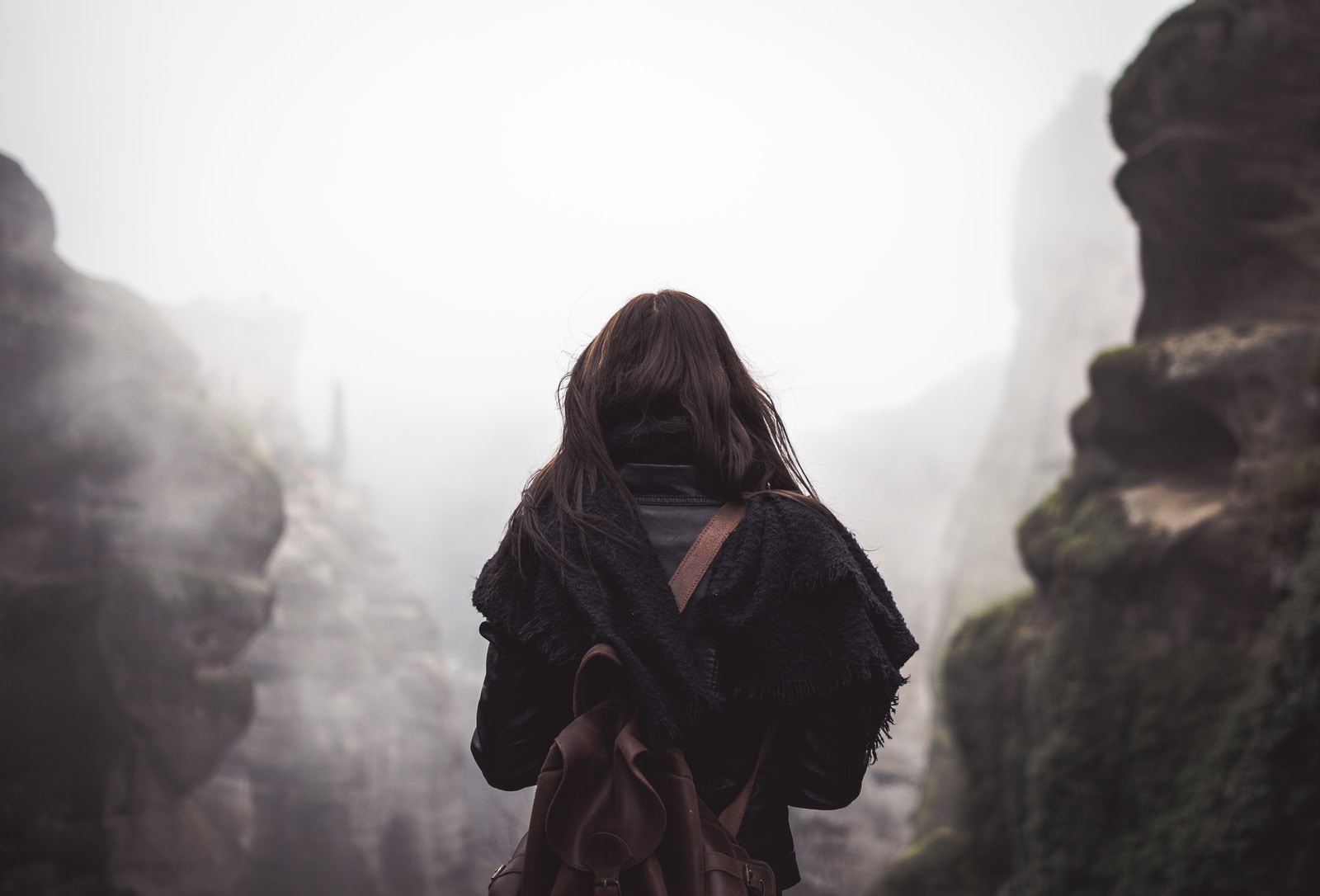 4 years ago this day, I traveled solo for the first time.woman carrying brown backpack standing in front of mountains during daytime